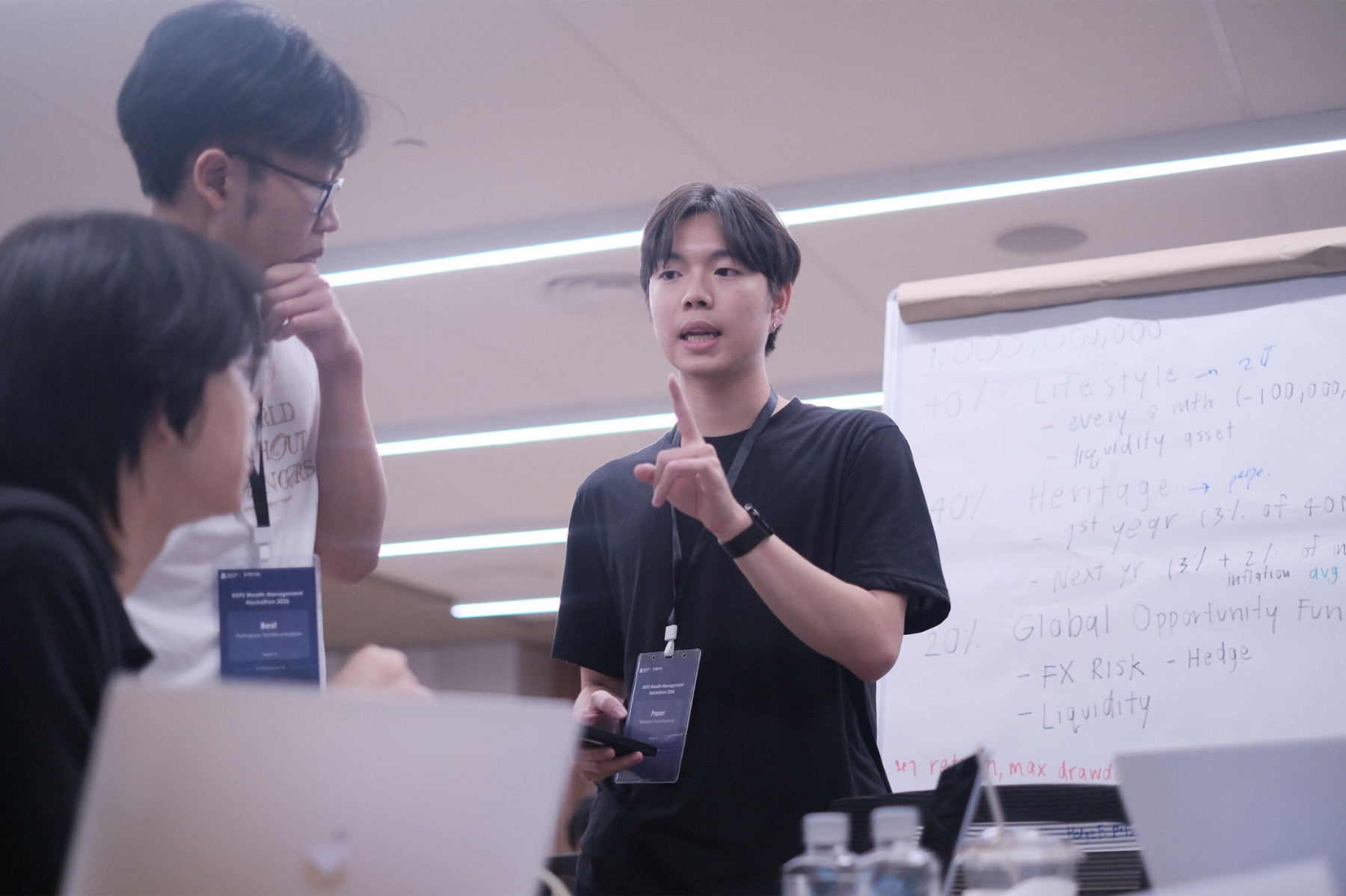 A participant explains an investment idea to teammates